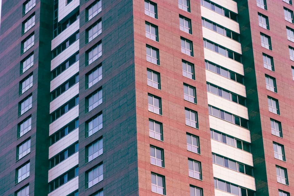 Close-up of a modern high-rise building with glass windows and geometric patterns.